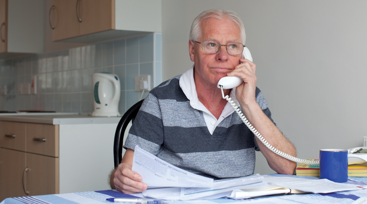 Man handling a phone scam