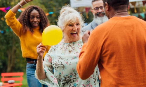 A group of friends and family celebrate a garden party