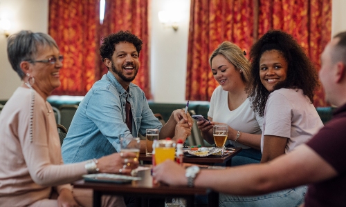 A group of friends taking part in a pub quiz