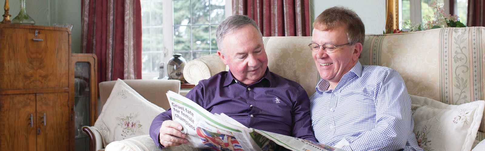 Couple reading newspaper