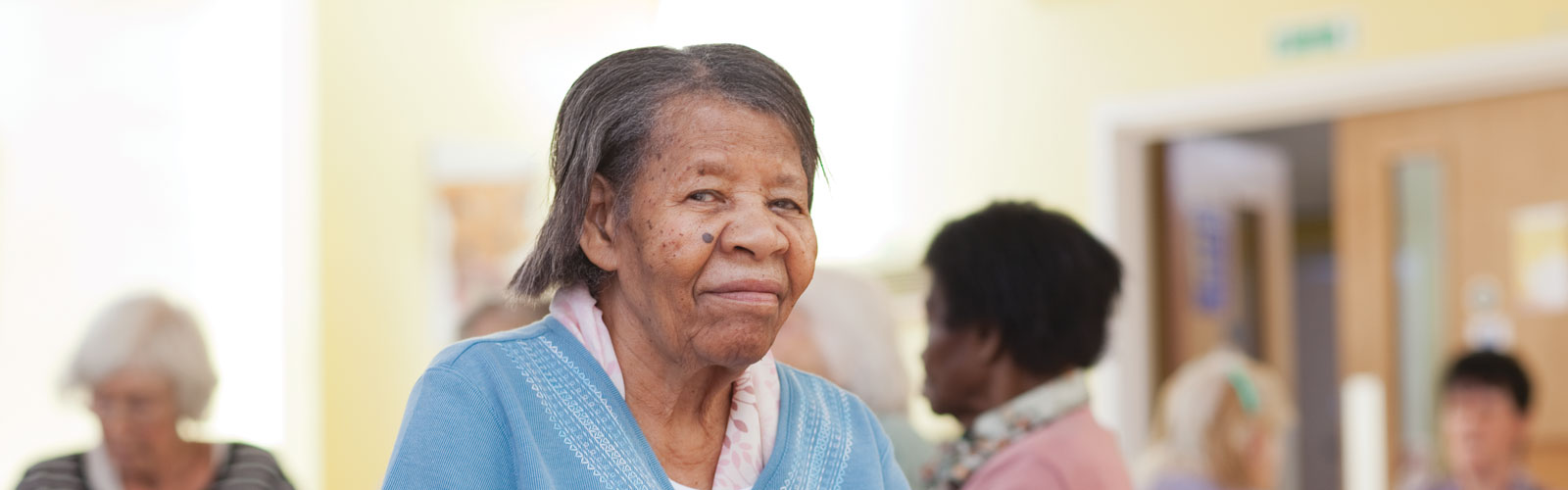 An older lady sat in a car home