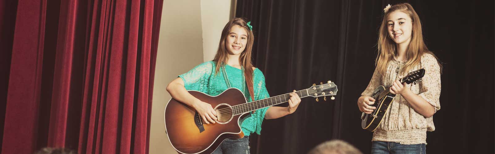 Two girls playing guitar