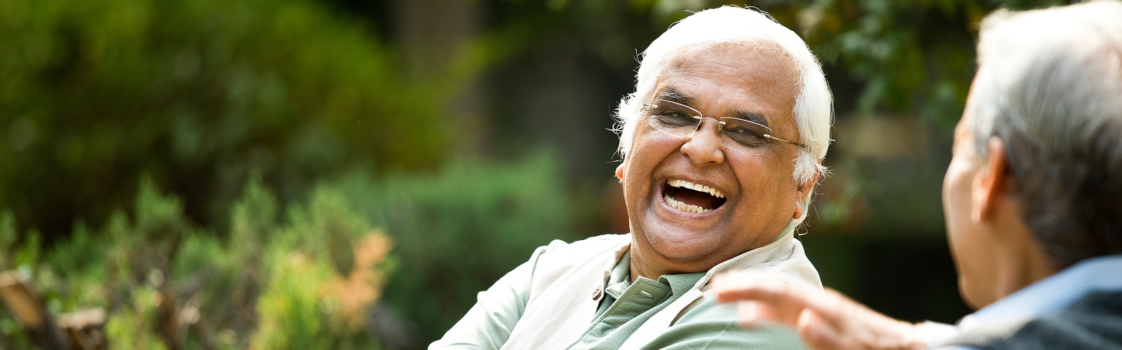 An older man smiling with a friend