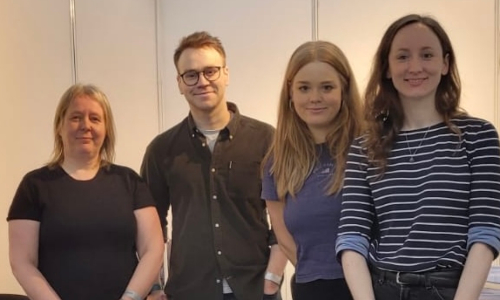 Four members of Age UK staff, stood in a line