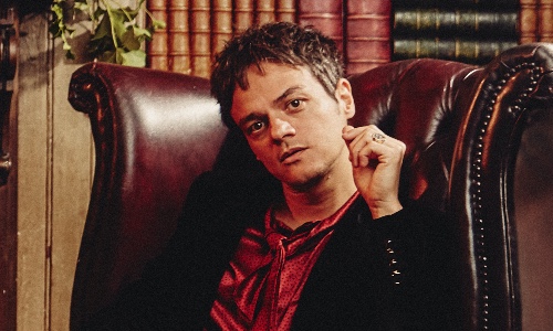 Singer-songwriter Jamie Cullum, sat in a chair