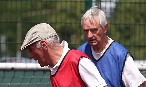 Two older men playing walking football